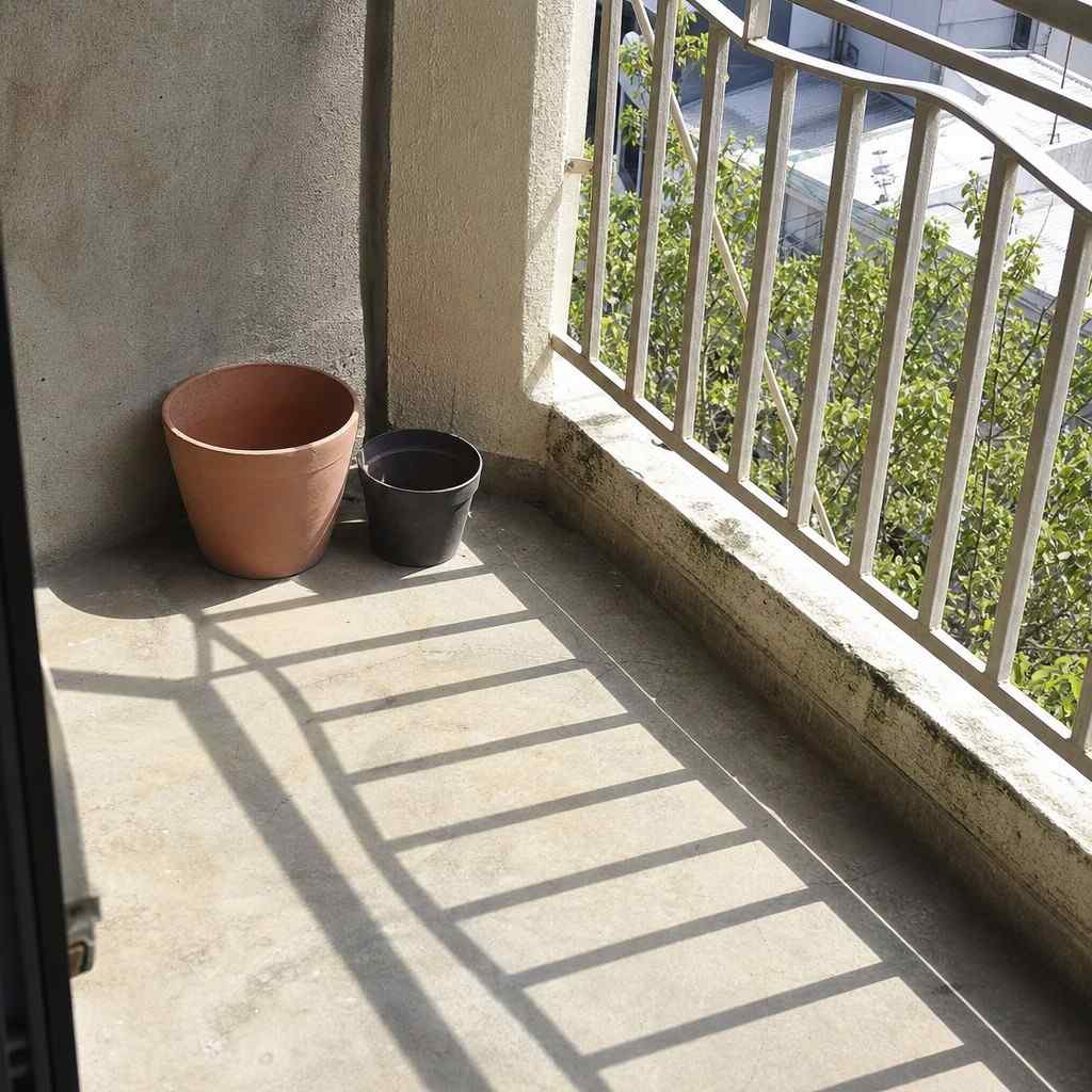 Morning sunlight falling across an empty corner of a small balcony
